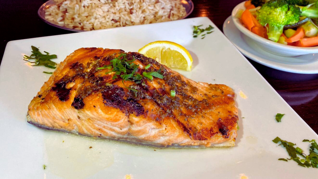 Salmon with rice and broccoli on a plate - Adam Tobin Law