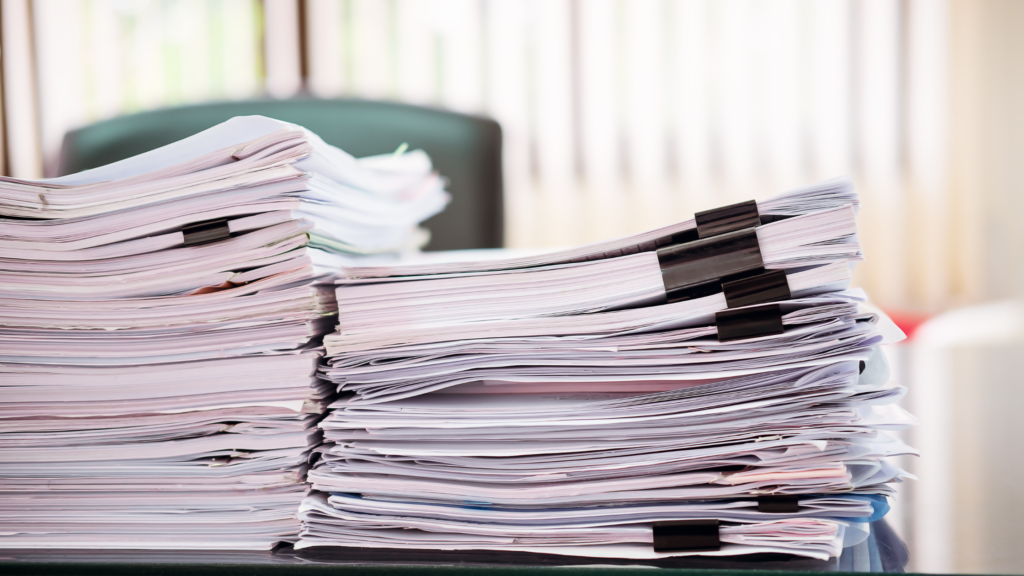 lots of paperwork on a desk - adam tobin law