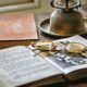 Book, old glasses and an old lantern on a table